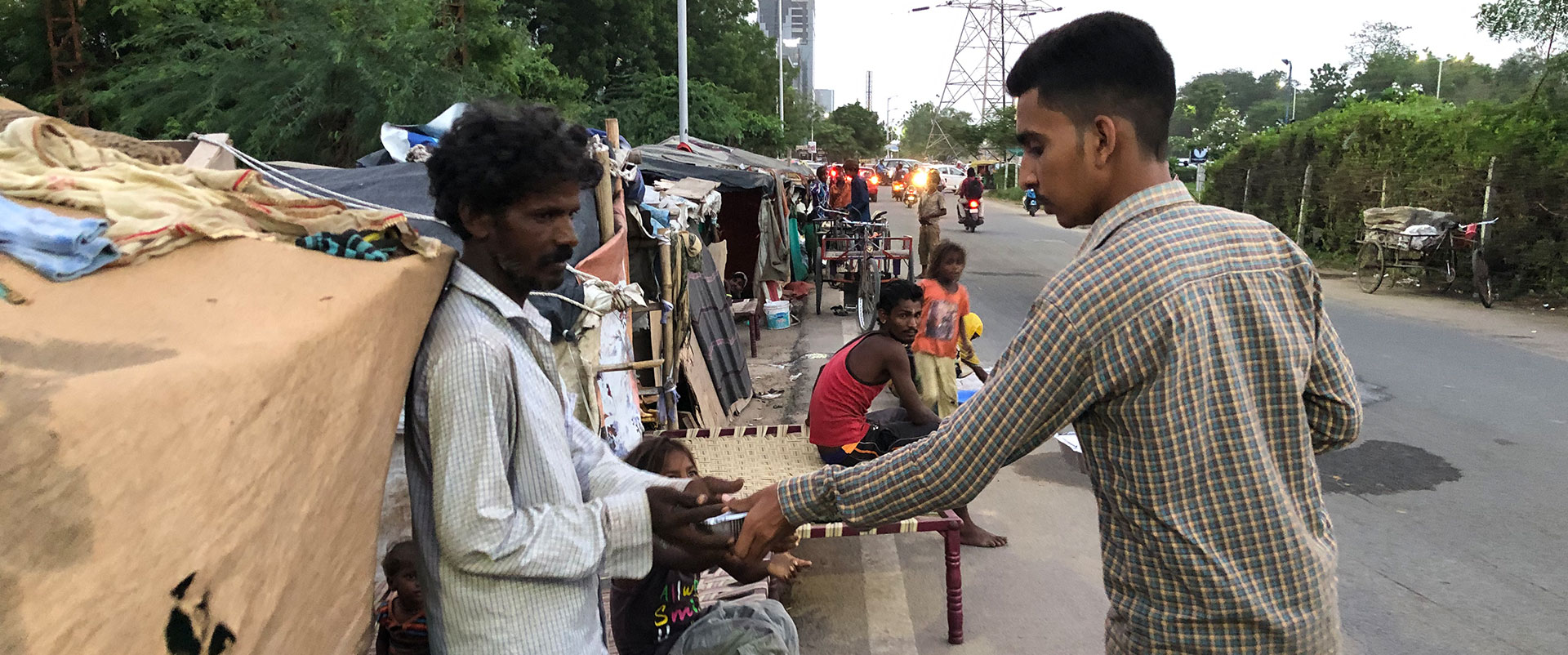 distributing food to homeless family by V3Cube