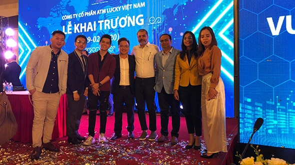 V3Cube team attending a client’s mobile app launch event in Vietnam, celebrating successful project collaboration